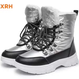 A pair of New Arrivals waterproof, anti-slip PU upper women’s snow boots with adjustable lock lace-up design, fur lining, black laces, thick white soles, and quilted detail is shown against a white background.