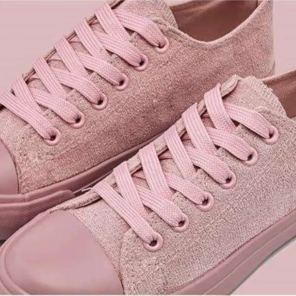 A pair of Wholesale Factory Painted Plush Solid Canvas Shoes Adult Sports Flat Sport Rubber Sneakers in pink, featuring matching laces and rubber soles, is displayed side by side on a light pink background. OEM and ODM customization available.