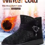 A pair of black wholesale OEM ODM plush thick waterproof faux fur ankle snow boots for women, featuring warm, antiskid, and watertight qualities, is displayed against a snowy forest backdrop.