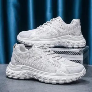A pair of OEM Trendy Tire Sole Men Shoes—light, anti-slip, wear-resistant sneakers with cotton mesh and EVA sole—displayed on a gray surface before a blue curtain; ideal for ODM/OEM orders.