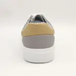 The New Arrivals Wholesale Band Vulcanized Fashion Leather Casual Canvas Shoes for Men features a grey design with a tan heel patch, white sole, and white laces—perfect for OEM ODM customization, shown from the back on a plain white background.