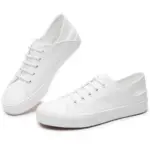 A pair of Fashion Low Top PU Upper Flat Black Walking Canvas Shoes for women with black laces and rubber soles—ideal for OEM or ODM customization.