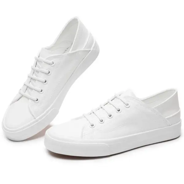 A pair of Fashion Low Top PU Upper Flat Black Walking Canvas Shoes for women with black laces and rubber soles—ideal for OEM or ODM customization.