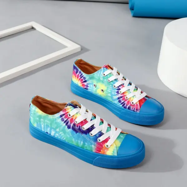 Wholesale Shoes Casual Blue Yellow Tie Dye Sport Classic Canvas Shoes for School, featuring vibrant multicolored uppers, white laces, blue soles, and OEM/ODM customization; perfect for trendy style on a gray surface.