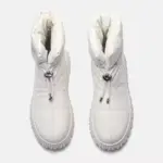 A pair of white, high-top, quilted genuine leather waterproof snow boots with plush fur lining and drawstring closures—ideal for wholesale OEM ODM customization for women’s winter footwear.
