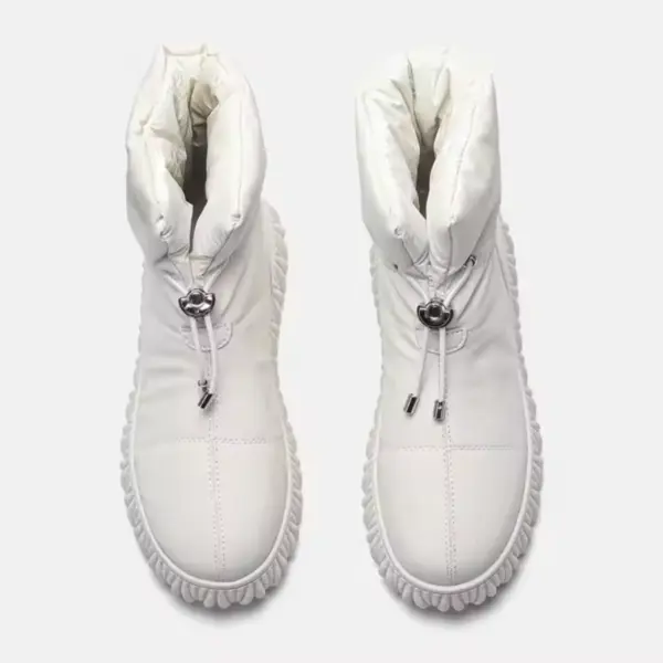 A pair of white, high-top, quilted genuine leather waterproof snow boots with plush fur lining and drawstring closures—ideal for wholesale OEM ODM customization for women’s winter footwear.