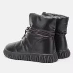 A pair of wholesale customized plush thick genuine leather waterproof fur boots for women, featuring cotton insulation and textured soles—ideal for OEM/ODM winter snow shoe customization.
