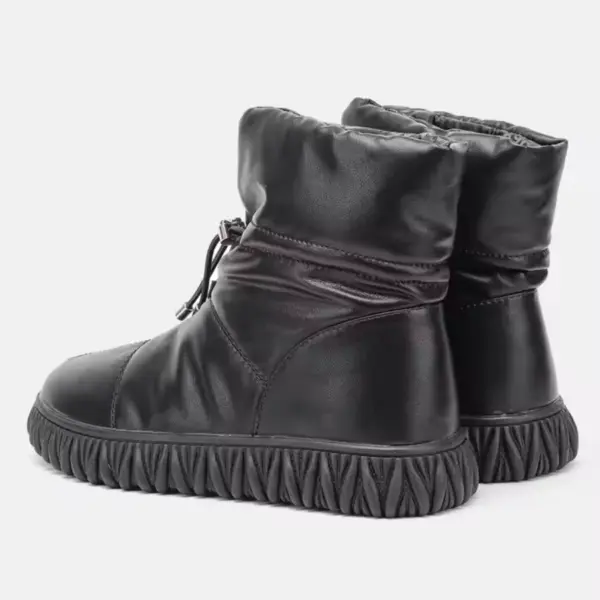 A pair of wholesale customized plush thick genuine leather waterproof fur boots for women, featuring cotton insulation and textured soles—ideal for OEM/ODM winter snow shoe customization.