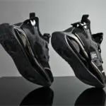 A pair of Wholesale Breathable Athletic Fitness Jogging Tennis Shoes Sport Running Sneakers for men with chunky soles, made by an OEM ODM manufacturer, are upright on a gray background highlighting the tread and side details.