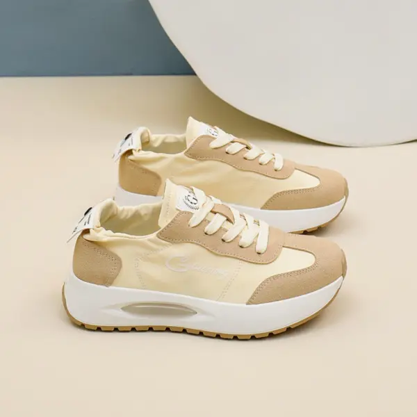 A pair of beige and white OEM ODM durable, wearable, breathable low top women's sneakers with white laces and chunky soles, designed for outdoor walking, wear-resistant, and available for customization.