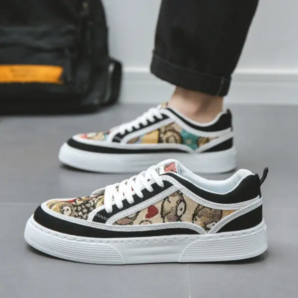 A person stands on a gray floor wearing Wholesale Factory 2024 Rubber Embossing Canvas Shoes, featuring laced, multicolored tapestry-style design with black trim and white laces.