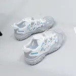 A pair of Factory Wholesale Hot Selling Thick Soled Sports Sneakers, breathable mesh PU women's shoes in white and gray with blue accents, is displayed on a light gray surface.
