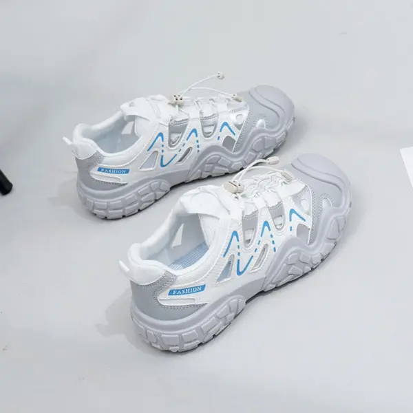 A pair of Factory Wholesale Hot Selling Thick Soled Sports Sneakers, breathable mesh PU women's shoes in white and gray with blue accents, is displayed on a light gray surface.