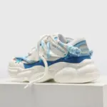 The 2024 Fashion Breathable Mesh Casual Sports Running Sneaker for Men features bold white and blue design, sculpted sole, and textured laces—perfect for OEM/ODM customization and wholesale fitness or walking styles.