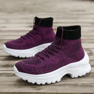A pair of XRH Wenzhou Factory women's chunky high-top sneakers with knit uppers and thick soles, designed for casual running and walking, crafted through OEM ODM services, displayed on a wooden surface.