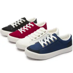 Four pairs of men's wholesale custom classic denim upper lace-up canvas sneakers—available for OEM & ODM—come in black, red, white, and blue with white laces and rubber soles, arranged diagonally on a white background.