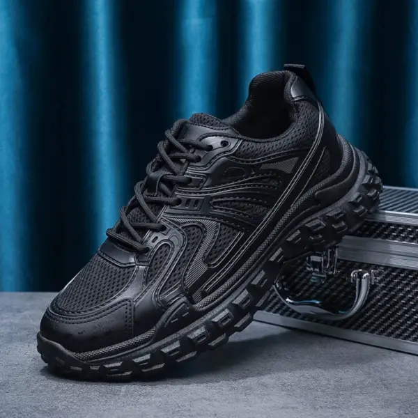 The OEM Trendy Tire Sole Men's Light Anti-slip Wear Resistant Sneaker, made of cotton mesh and EVA, is shown in black on a gray surface next to a metallic case, set against a blue curtain background.