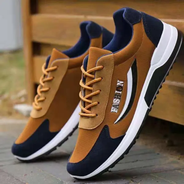 A pair of brown and navy blue high-quality gym casual cushioning cotton sneakers for men, featuring "FASHION" on the side, shown outdoors near a wooden structure. Ideal for walking, hiking, OEM & ODM customization.
