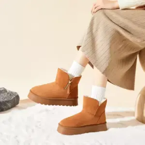 Person wearing the New Design Ladies Warm Winter Snow Weather Ankle Boots for Women Custom Fashion Platform Boots 2025 with white socks and a beige skirt—stylish inspiration for upcoming OEM ODM fashion collections.