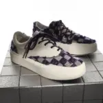 A pair of Bulk Zapatos De Hombre Custom Classic Embroidery Skateboarding Canvas Shoes for Men with white base, purple checkered pattern, white soles, and dark laces displayed on a metallic tiled surface.