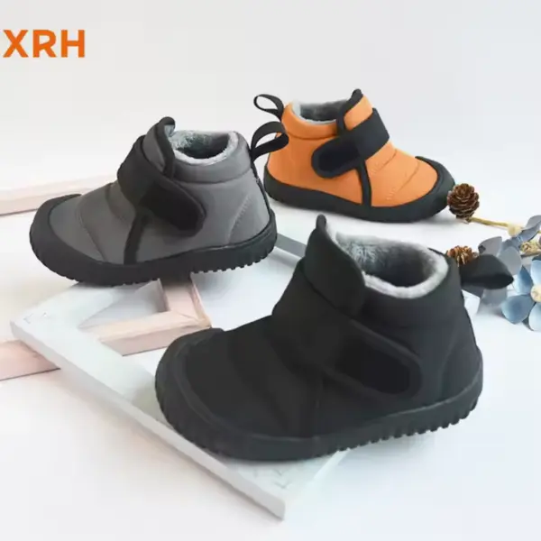 Three pairs of XRH Cold Sticky Casual Ladies Winter Children’s Baby Short Snow Boots in black, gray, and orange with Velcro straps are on display with flowers and pinecones. OEM/ODM custom manufacturing is available.