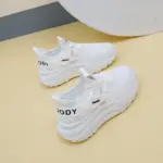 A pair of 2025 summer low-price mesh round toe sneakers, slow walking lace-up women's shoes, shown on a light yellow surface—ideal for OEM and ODM customization.