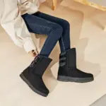 A person in dark blue jeans and a light jacket sits on the floor, highlighting Wholesale Fashion Western Designer Fur Snow Boots—stylish black winter footwear for women, ideal for 2024 OEM/ODM collections.