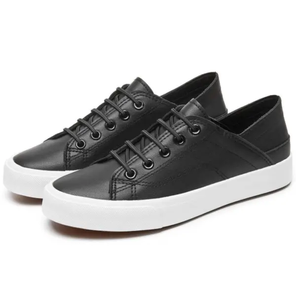 A pair of Fashion Low Top PU Upper Black Walking Canvas Sneakers for Women with white rubber soles and black laces, displayed side by side on a white background—ideal for OEM or ODM customization.