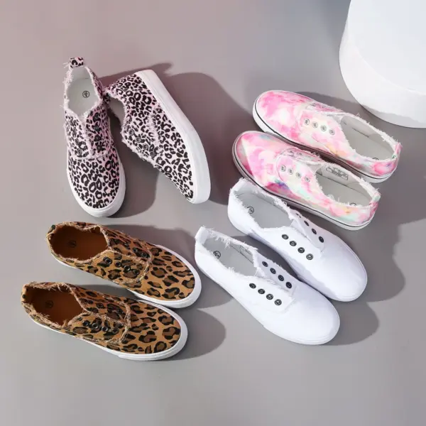 Four pairs of Hot Sale Casual Low Top No Lace Lazy Canvas Shoes for Women, customizable via OEM/ODM, are arranged on a gray surface: pink leopard, tie-dye pink, brown leopard, and plain white with random fluff decoration.