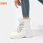 A person wearing New Arrivals Waterproof Zipper Anti-Slip Adjustable Lace-Up PU Upper Fur Lined Warm Women's Snow Winter Boots with rolled-up blue jeans stands against a plain white background.