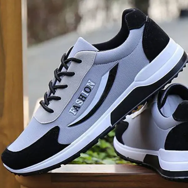 A pair of gray and black High Quality Gym Casual Cushioning Sneakers for men, featuring "FASHION" on the side, displayed on a wooden surface.