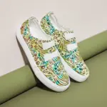 A pair of XRH Wholesale Cheap Price Pink Slip on Women's Casual Canvas Shoes for Women New Style 2025 is displayed against a green and beige background.