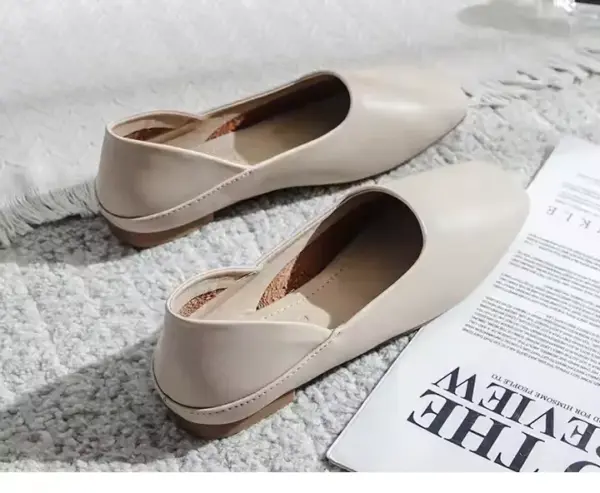 A pair of Slingbacks Square Flat Shoes for Women in beige, suitable for OEM ODM orders, is displayed on a textured carpet beside an open magazine and a fringed blanket.