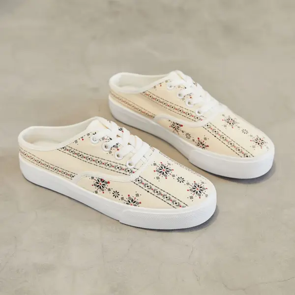 A pair of XRH Wholesale cream canvas slippers with white soles and small multicolored floral prints, designed for OEM/ODM custom logos, displayed on a light gray surface. Suitable for women, men, and kids.