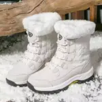 Pair of Customized Anti-slip Solid Color Winter Laced Snow Boots with thick soles and cotton lining stand on snow, perfect for OEM/ODM orders. Women's rubber shoes for warmth and comfort in winter conditions.