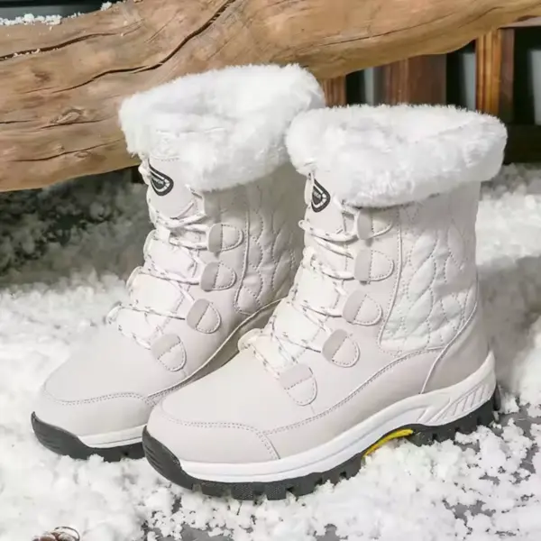 Pair of Customized Anti-slip Solid Color Winter Laced Snow Boots with thick soles and cotton lining stand on snow, perfect for OEM/ODM orders. Women's rubber shoes for warmth and comfort in winter conditions.