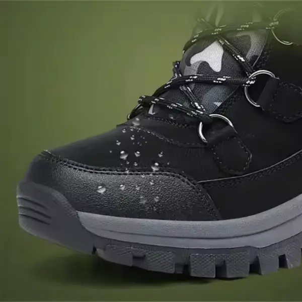 Close-up of a Wholesale Black Mixed Anti-slip Women Snow Boot, featuring TPR, PU, canvas, plush lining, and laced cotton design with water droplets on its surface against a green background.