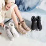 A person sits on snow in a light outfit, with four pairs of grey, white, beige, and black Women's Leather Sports Ankle Sneakers Boots—customizable logo, waterproof, outdoor-ready, and fur-lined for warmth—lined up beside them.