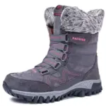 Wholesale customizable leather women’s snow boots feature a gray design with pink accents, faux fur lining, rugged rubber sole, lace-up front, and “FASHION” printed on the side. OEM and ODM orders welcome.