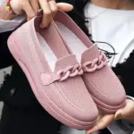 A person holds a pair of pink Spring Shoes for Women featuring a knit texture and decorative chain detail on the front, highlighting stylish OEM ODM footwear choices.