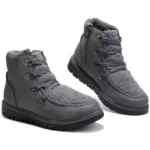A pair of black leather high-top flat heel ladies' winter boots, available at low prices for wholesale OEM/ODM customization.