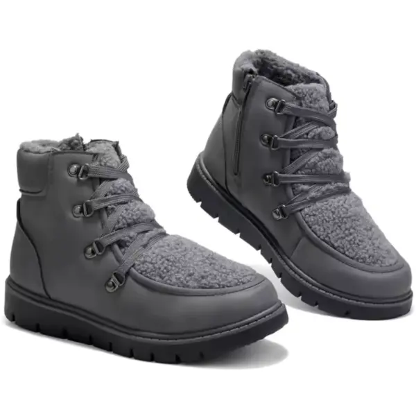 A pair of black leather high-top flat heel ladies' winter boots, available at low prices for wholesale OEM/ODM customization.