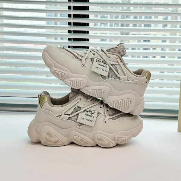 A pair of Women's Low Top Mesh Thick Sole Height Increasing Wear Resistant Outdoor Sports Sneakers are stacked on a tabletop in front of a window with horizontal blinds.
