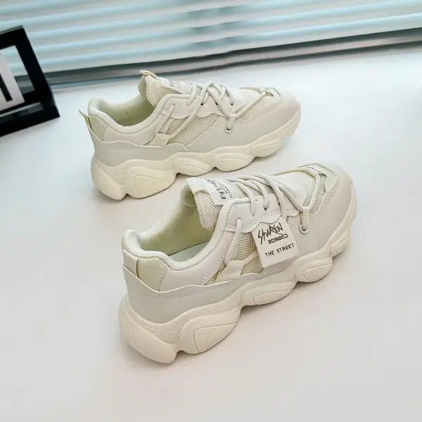 A pair of Women's Sneakers Low Top Mesh Thick Sole Height Increasing Wear Resistant Outdoor Sports Shoes are placed side by side on a white surface near a window.