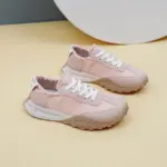 A pair of New Mesh Breathable Sports Sneakers Summer PU Women's Rubber Lace up Shoes in light pink with white laces and textured beige soles, displayed on a beige surface.