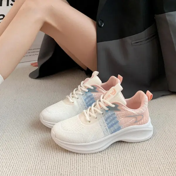 A person wearing Factory Custom Spring New Styles Sports Sneakers—chunky, comfortable, non-slip, height-increasing women’s shoes in white with blue and pink accents—sits on a light carpet with a dark jacket over their lap.