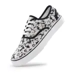 2025 Factory New Style Mixed Trendy Adult Canvas Shoes—white sneakers with black abstract splatter, white laces, and thick white sole. Available for OEM or ODM customization; perfect for women’s outdoor walking.