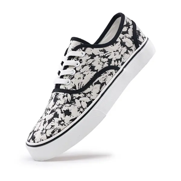 2025 Factory New Style Mixed Trendy Adult Canvas Shoes—white sneakers with black abstract splatter, white laces, and thick white sole. Available for OEM or ODM customization; perfect for women’s outdoor walking.