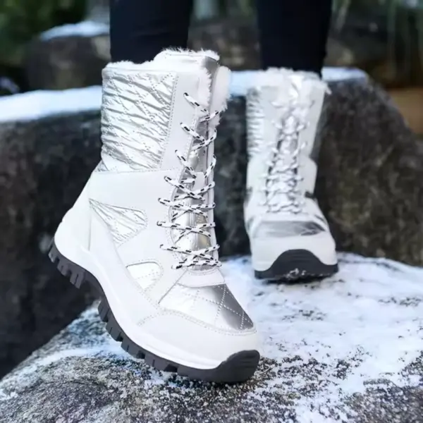 A person wearing Wholesale Mountain Outdoor Hiking Wear Resistant Women's Snow Boots, TPR EVA thick-soled cotton shoes, stands on a snow-dusted rock outdoors.