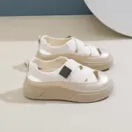 A pair of 2024 OEM ODM PU hollow skateboard outdoor walking women's sandals with wear-resistant mesh, white and beige colors, closed toes, thick soles, and crisscross straps—perfect for summer customization.